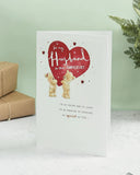 Close-up of UK Greetings adorable bears husband anniversary greeting card with cute bear illustrations and heartfelt message inside