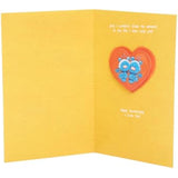 Pop-up heart anniversary greeting card for him and her by UK Greetings, showing a colorful 3D heart design inside.