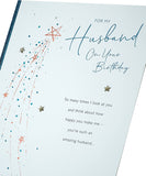 Loving birthday greeting card for husband featuring heartfelt words, UK Greetings brand, with colorful floral design on the front.