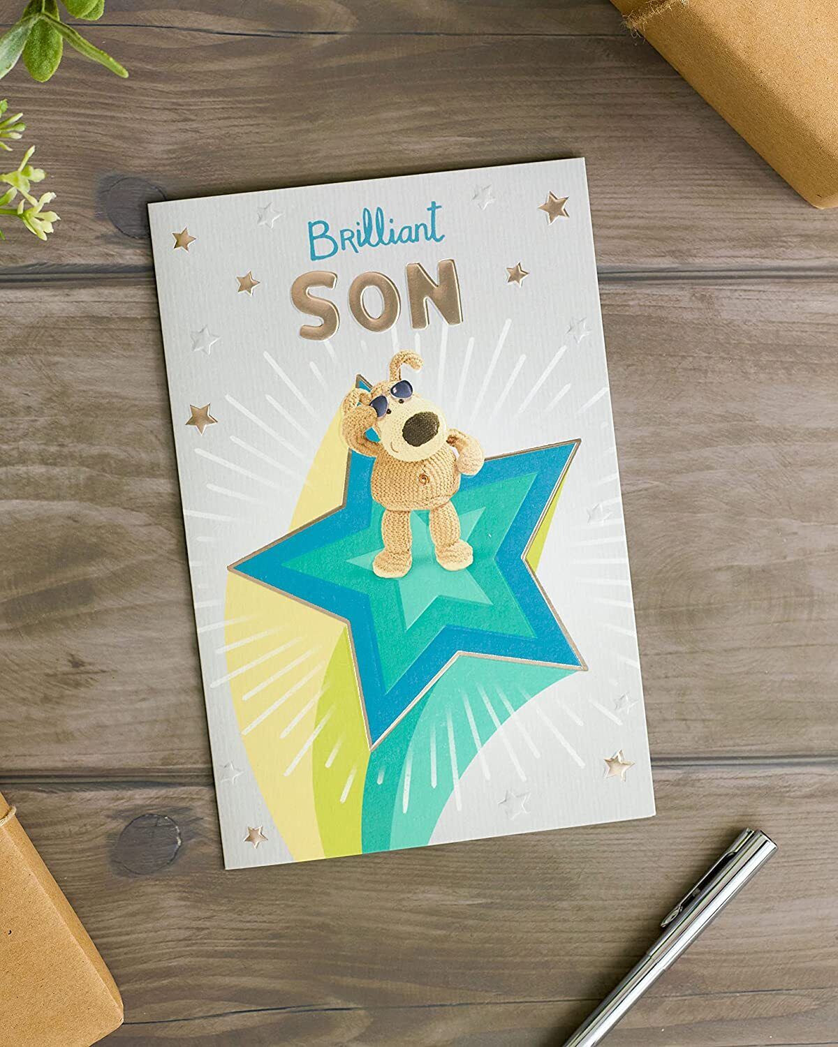 Greeting card featuring Boofle standing on a star with "Brilliant Son" birthday message, UK Greetings product image.