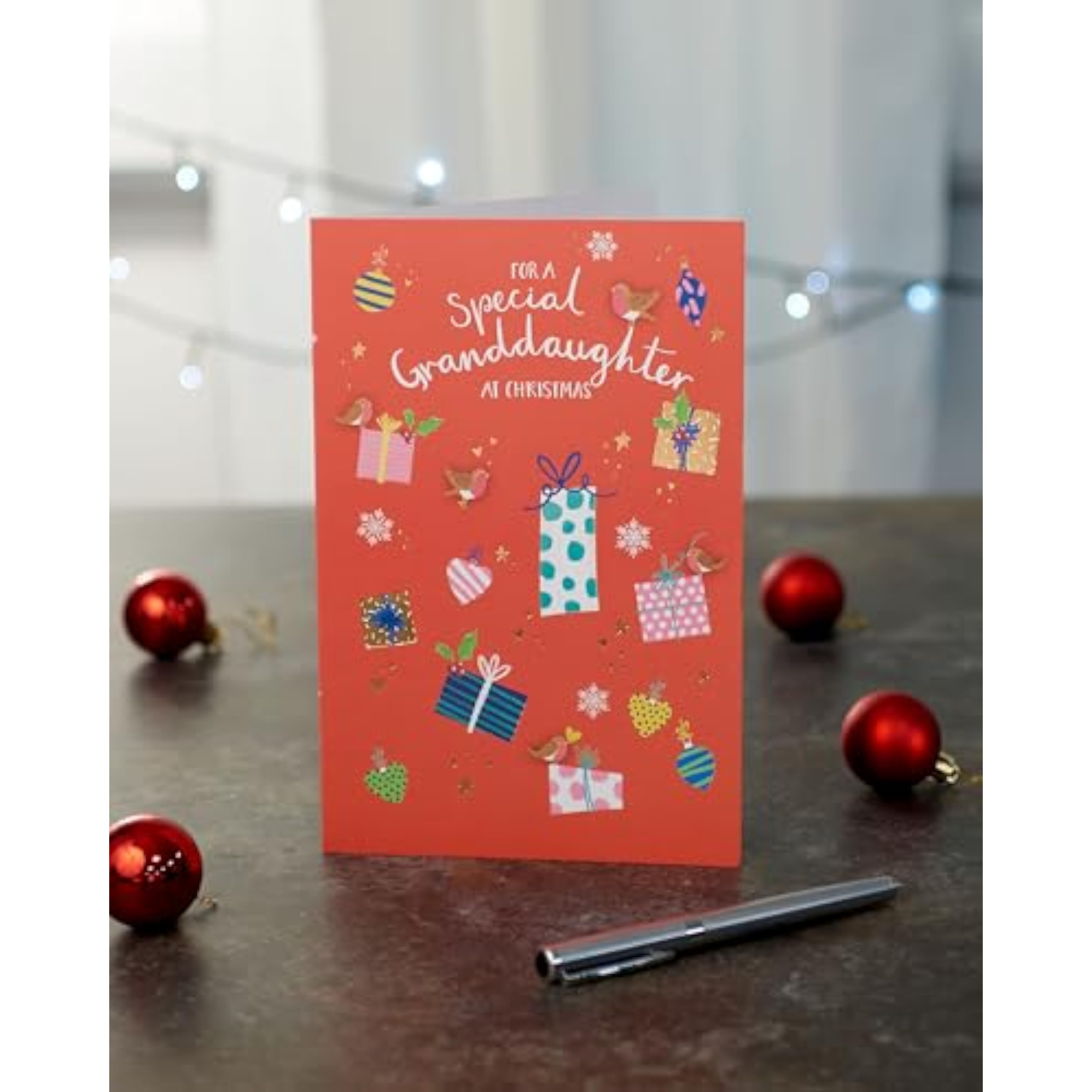 Christmas greeting card for granddaughter with foil design featuring sweet presents, from UK Greetings.
