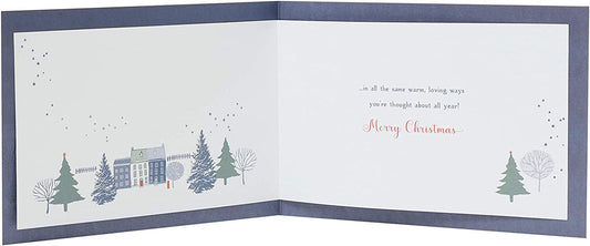 Festive Christmas Town Scene greeting card for couples by UK Greetings, featuring holiday-themed illustrations in a warm, festive setting.