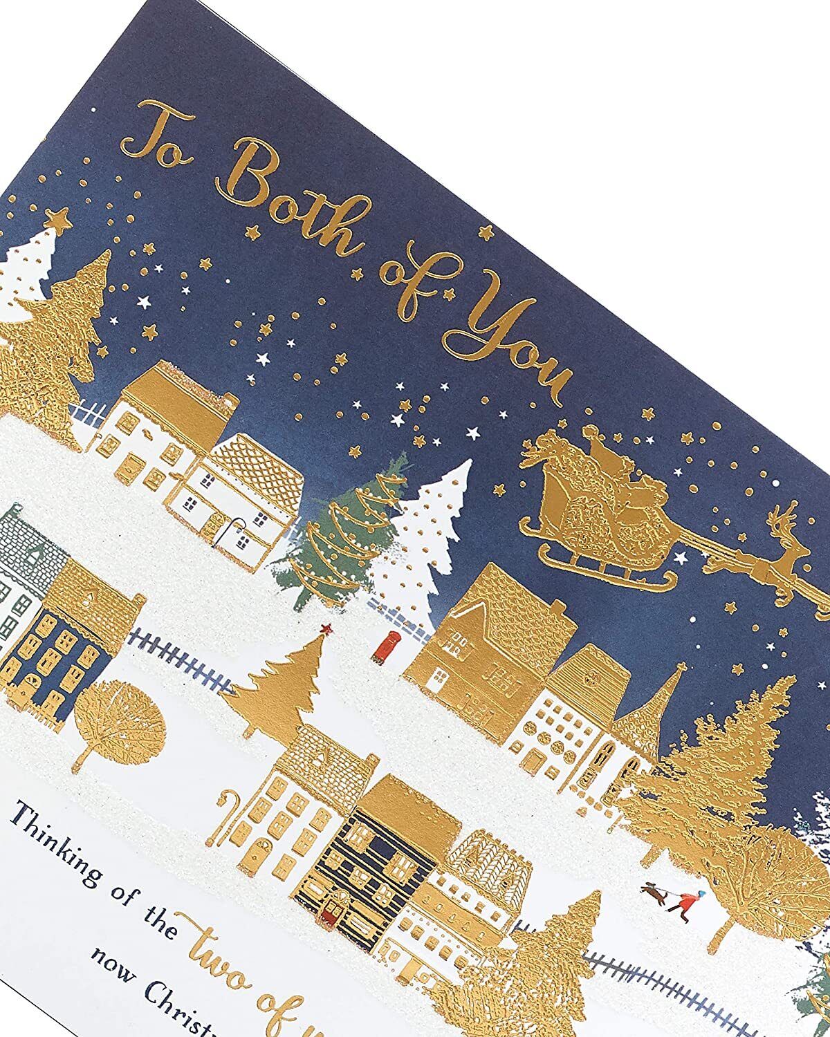 Festive Christmas Town Scene greeting card featuring a couple, UK Greetings holiday greeting card with detailed winter village illustration.