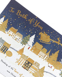 Festive Christmas Town Scene greeting card featuring a couple, UK Greetings holiday greeting card with detailed winter village illustration.