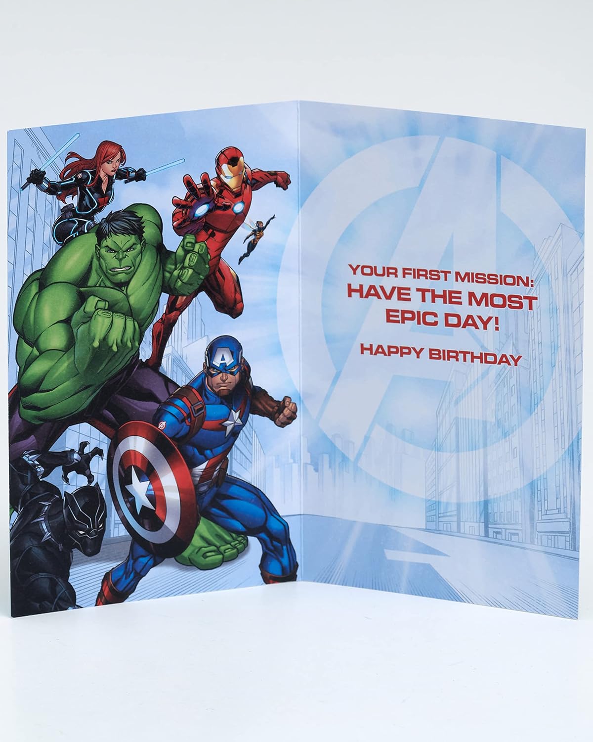 Colorful Avengers boy birthday greeting card with superhero characters, designed by UK Greetings, featuring vibrant comic-style artwork.