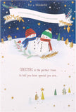 A festive greeting card featuring a snowman hugging a child, with holiday-themed decorations and "Merry Christmas" message.