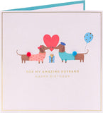 Cute sausage dog husband birthday greeting card from UK Greetings featuring a charming illustration of a sausage dog.
