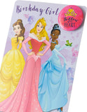 Disney Princess greeting card featuring Belle, Aurora, and Tiana with colorful birthday-themed illustrations.