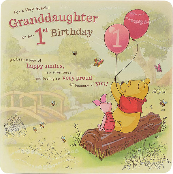Disney Winnie the Pooh granddaughter 1st birthday greeting card with colorful illustration and cheerful design for special occasion.