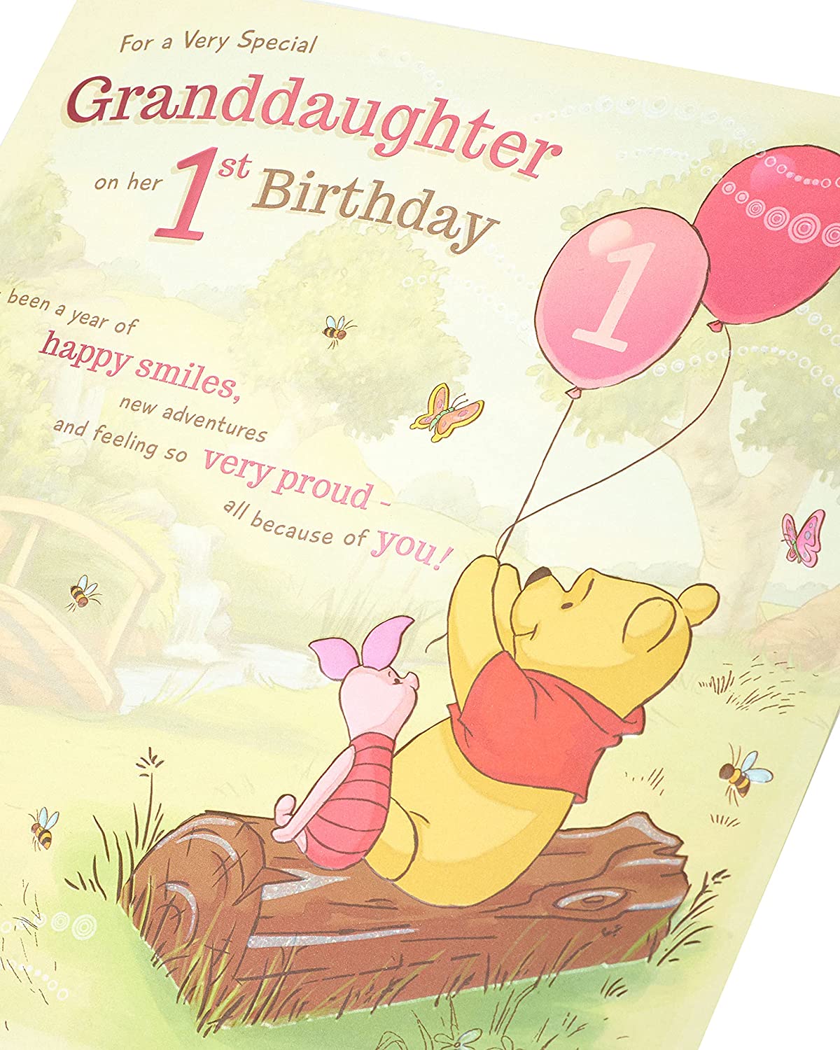 Disney Winnie the Pooh granddaughter 1st birthday greeting card from UK Greetings, featuring Winnie the Pooh and cheerful birthday message.
