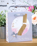 Elegant bridesmaid gift bag greeting card from UK Greetings, featuring floral designs and heartfelt message for special occasions.