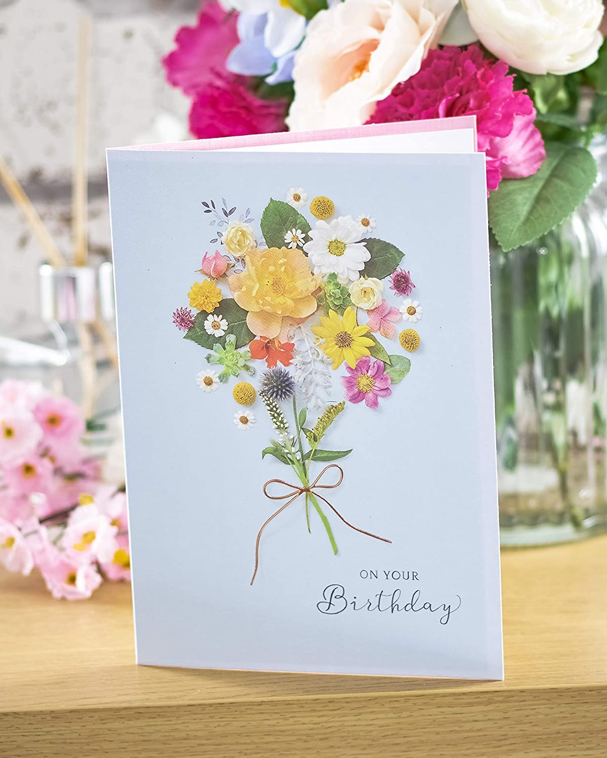 Elegant floral posy birthday greeting card with metallic shine, featuring colorful flower designs on high-quality cardstock.