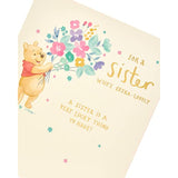 Disney Winnie the Pooh birthday greeting card featuring flowers, from UK Greetings, with a charming illustration of Pooh and a sister.