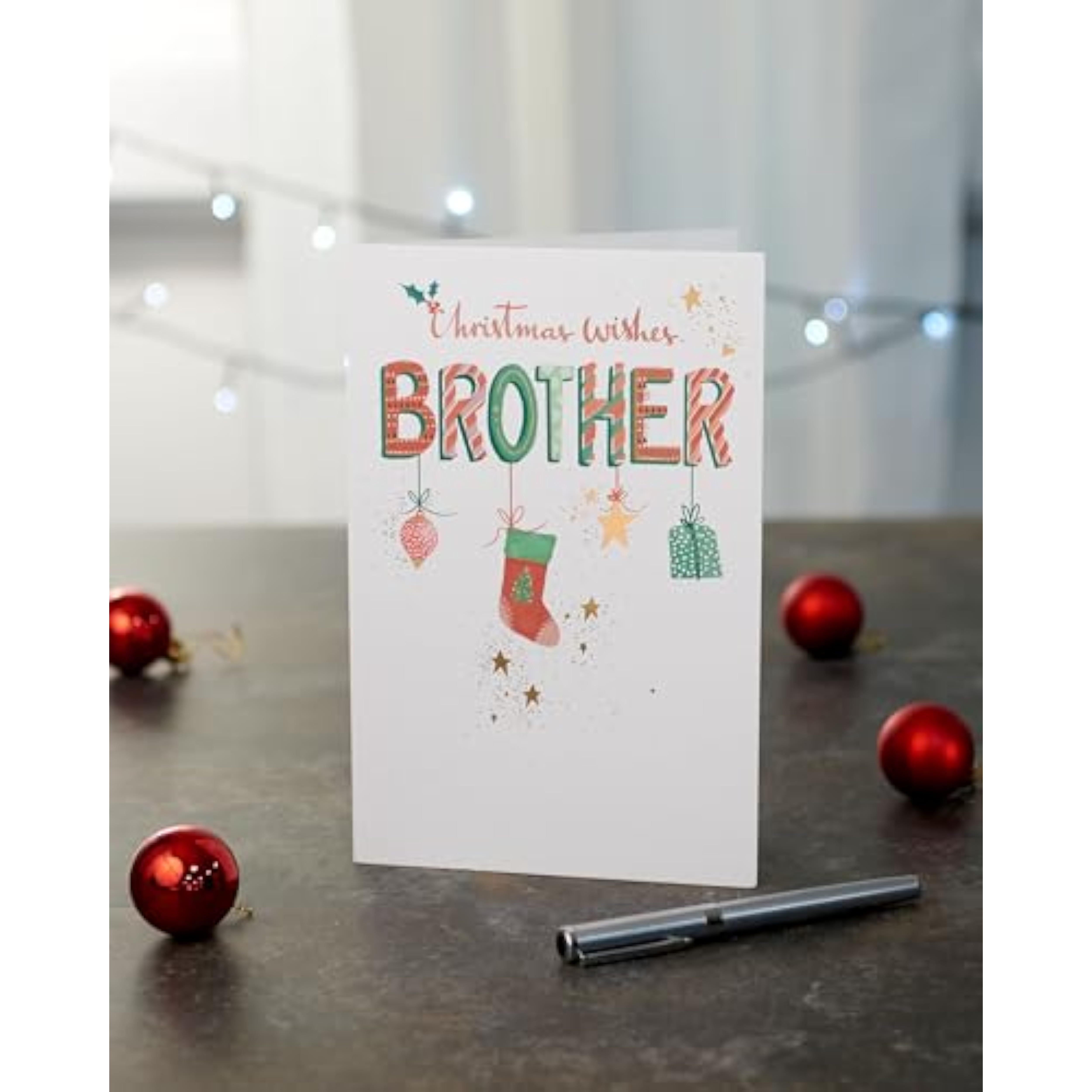 Festive hanging Christmas ornament greeting card for brother by UK Greetings, featuring colorful holiday-themed designs.
