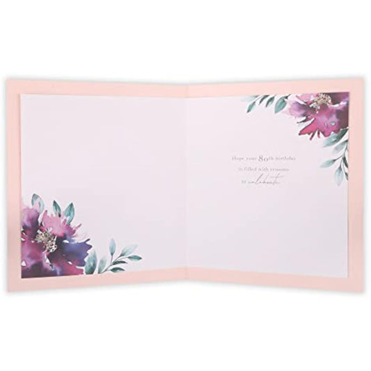 Floral 80th birthday greeting card by UK Greetings featuring colorful floral design for milestone celebration.