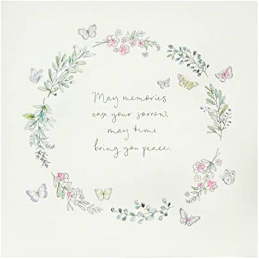 Floral butterfly sympathy greeting card by UK Greetings featuring delicate flower and butterfly illustrations on a heartfelt design.