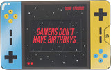 Open male birthday greeting card featuring game design elements from UK Greetings, with colorful illustrations and cheerful message inside.
