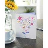 Greeting card featuring a flower and heart design with gold accents, perfect for a girlfriend's birthday from UK Greetings.