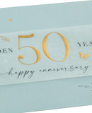 Golden 50th anniversary leaves greeting card by UK Greetings featuring elegant leaf designs on a celebratory card.