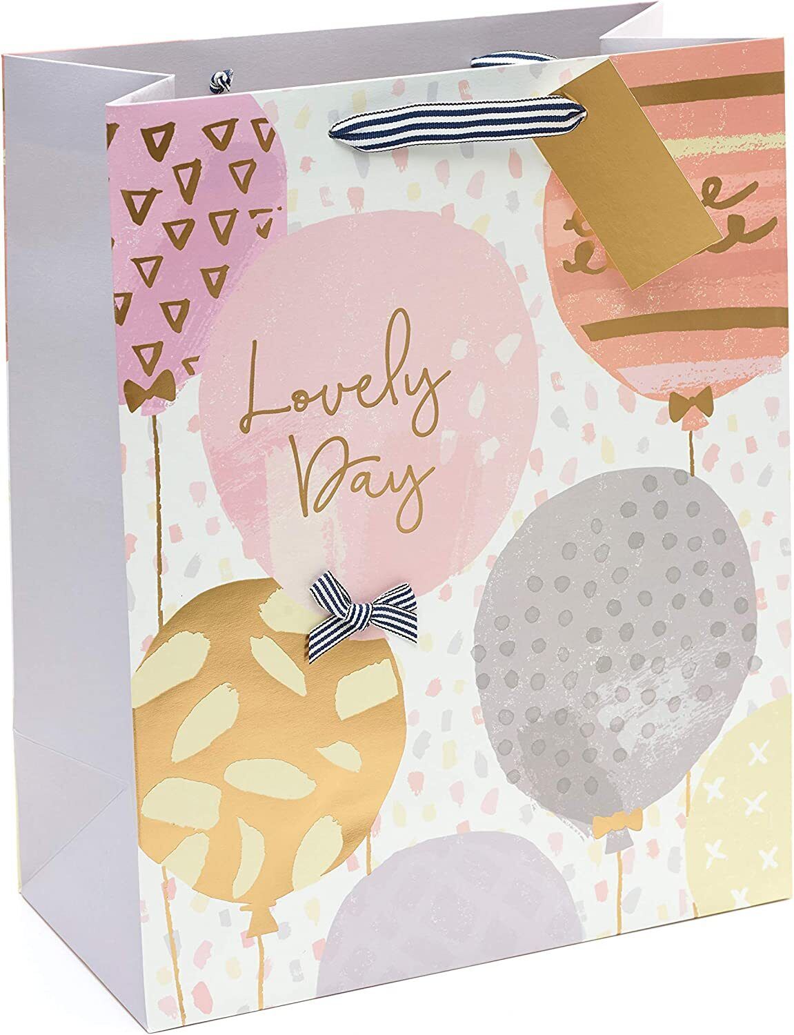 Golden balloon large birthday gift bag with greeting card from UK Greetings, featuring festive balloon and gift wrap design.