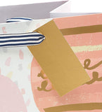 Golden balloon birthday gift bag featuring a greeting card with colorful balloon illustrations, perfect for celebratory occasions.