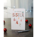 Hanging Christmas ornaments themed greeting card for sister, UK Greetings, featuring festive holiday design and decorative ornaments.