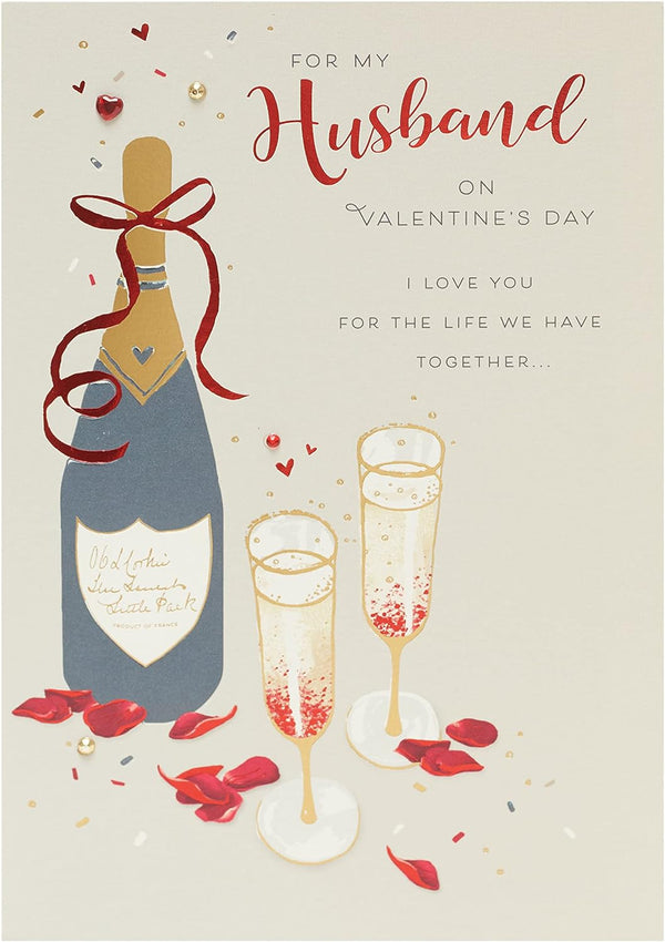 Husband Valentine's Day greeting card with champagne design and envelope from UK Greetings, featuring elegant floral and champagne illustrations.