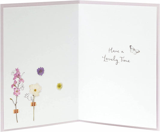 Floral birthday greeting card from the Into The Meadow range by UK Greetings, featuring colorful flower illustrations.