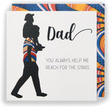 Kindred X Afrotouch birthday greeting card titled "Reach For The Stars Dad" featuring space-themed artwork and heartfelt message.