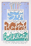 Laser-cut cake-shaped birthday greeting card from UK Greetings featuring intricate designs and vibrant colors.