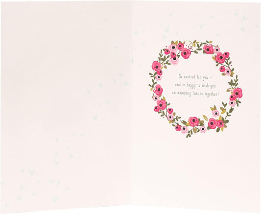 Laser-cut wedding car greeting card by UK Greetings featuring intricate floral and car designs on high-quality cardstock.