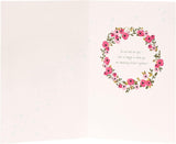 Laser-cut wedding car greeting card by UK Greetings featuring intricate floral and car designs on high-quality cardstock.