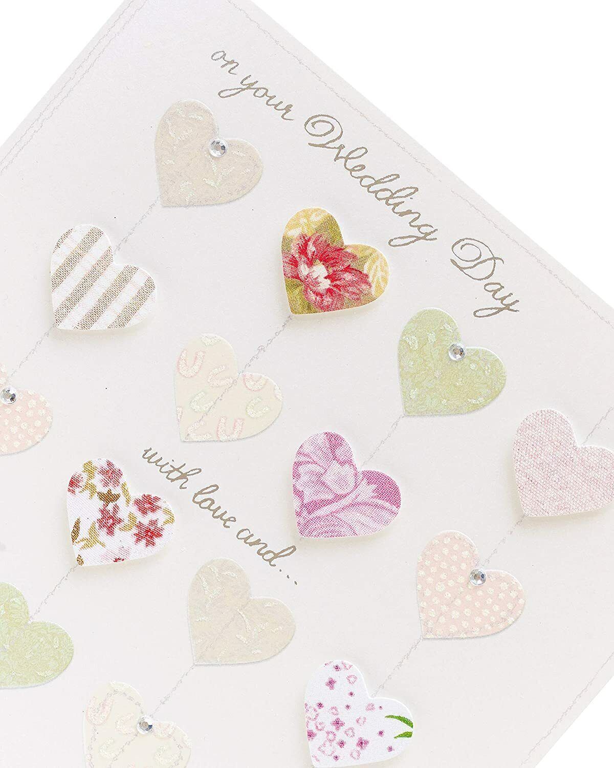 Luxury wedding greeting card by UK Greetings featuring 3D hearts and silver foil embellishments.