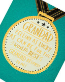 Father's Day greeting card for Grandad featuring a medal design, by UK Greetings, with colorful decorative elements.