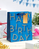Medium blue UK Greetings gift bag with birthday lettering and decorative design, suitable for gift wrapping and presentation.