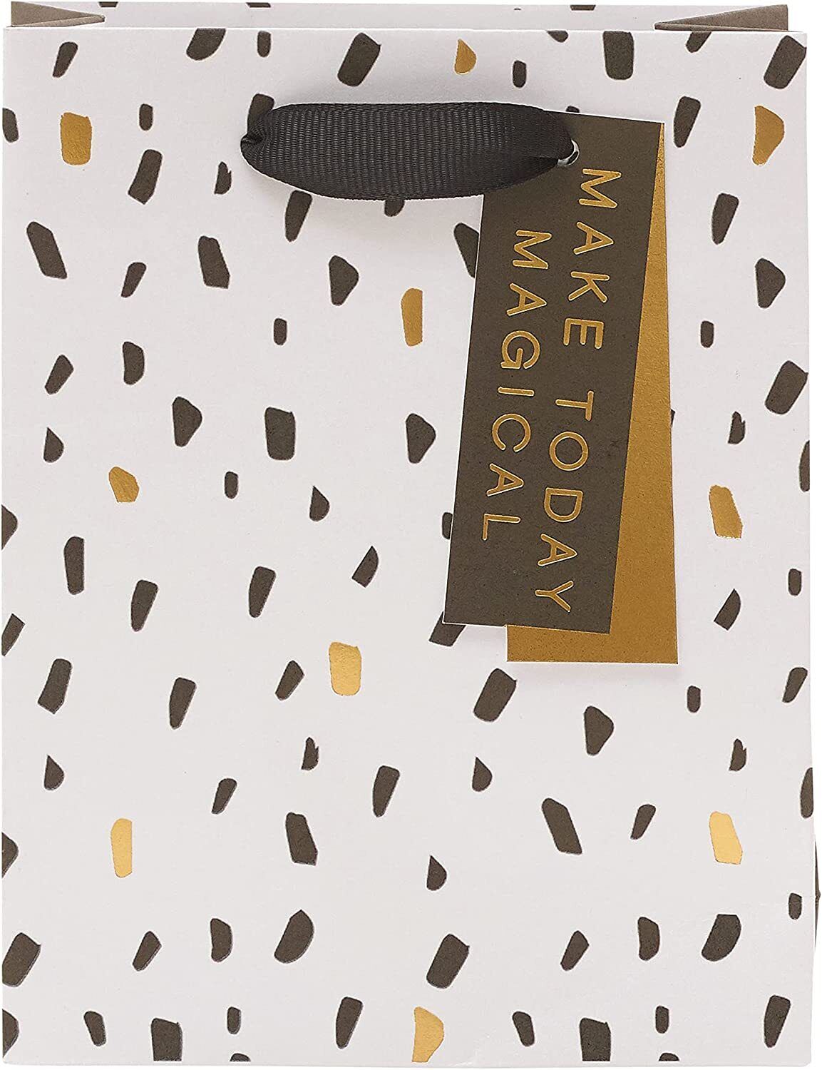 Elegant greeting card with modern design from UK Greetings, displayed alongside a stylish gift bag in a contemporary setting.