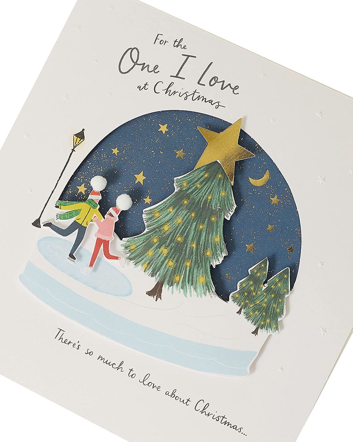 Romantic Christmas greeting card featuring a snow globe design, from UK Greetings, with festive holiday imagery and heartfelt message.
