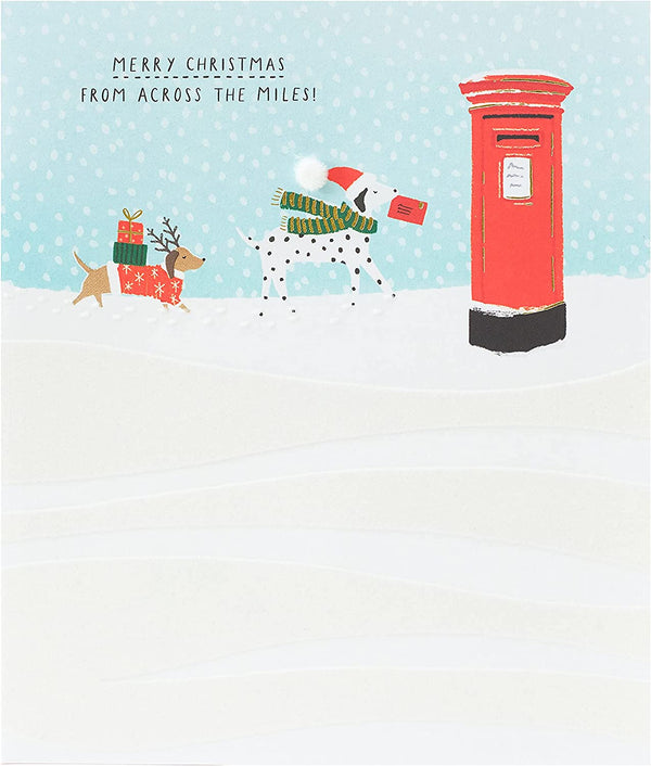 Festive Christmas greeting card featuring snow dogs across the miles, UK Greetings holiday greeting card with winter snow scene.