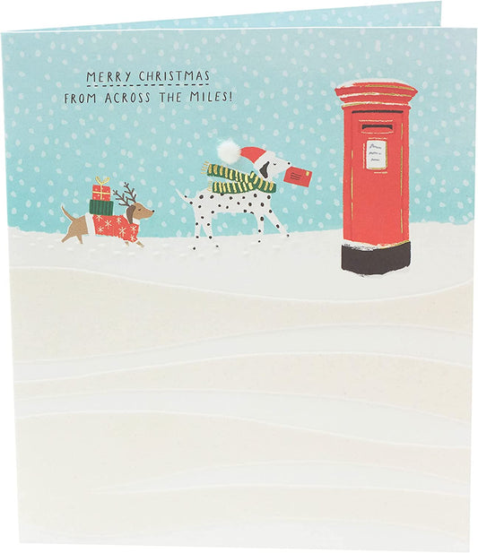 Festive Christmas greeting card featuring snow dogs across the miles design by UK Greetings, with holiday-themed artwork.