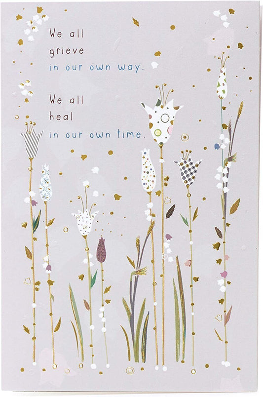 Gold foil sympathy greeting card titled "Caring Thoughts" by UK Greetings, featuring comforting design and heartfelt message.