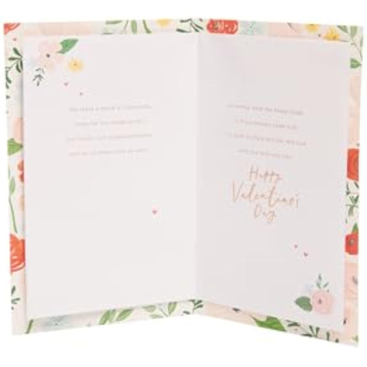 UK Greetings Valentine's Day greeting card for wife with bright floral design, featuring colorful flowers and heartfelt message.