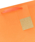 Bright orange UK Greetings gift bag with greeting card design, featuring vibrant colors and large size for special occasions.
