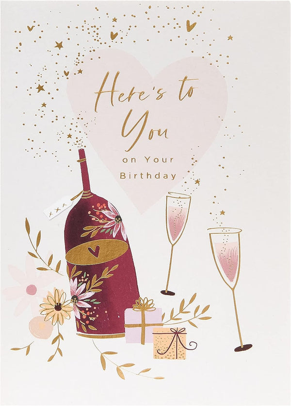 UK Greetings birthday greeting card featuring a wine bottle, glasses, and presents with colorful decorations.