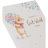Winnie the Pooh get well greeting card with flower and gold foil accents, from UK Greetings, featuring cheerful cartoon illustration.