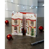 Festive 3D house-shaped Christmas greeting card for family from UKG, featuring colorful holiday design and festive details.