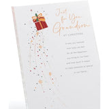 UKG Grandson Christmas greeting card with snowflakes and present festive design, featuring a cheerful holiday scene.