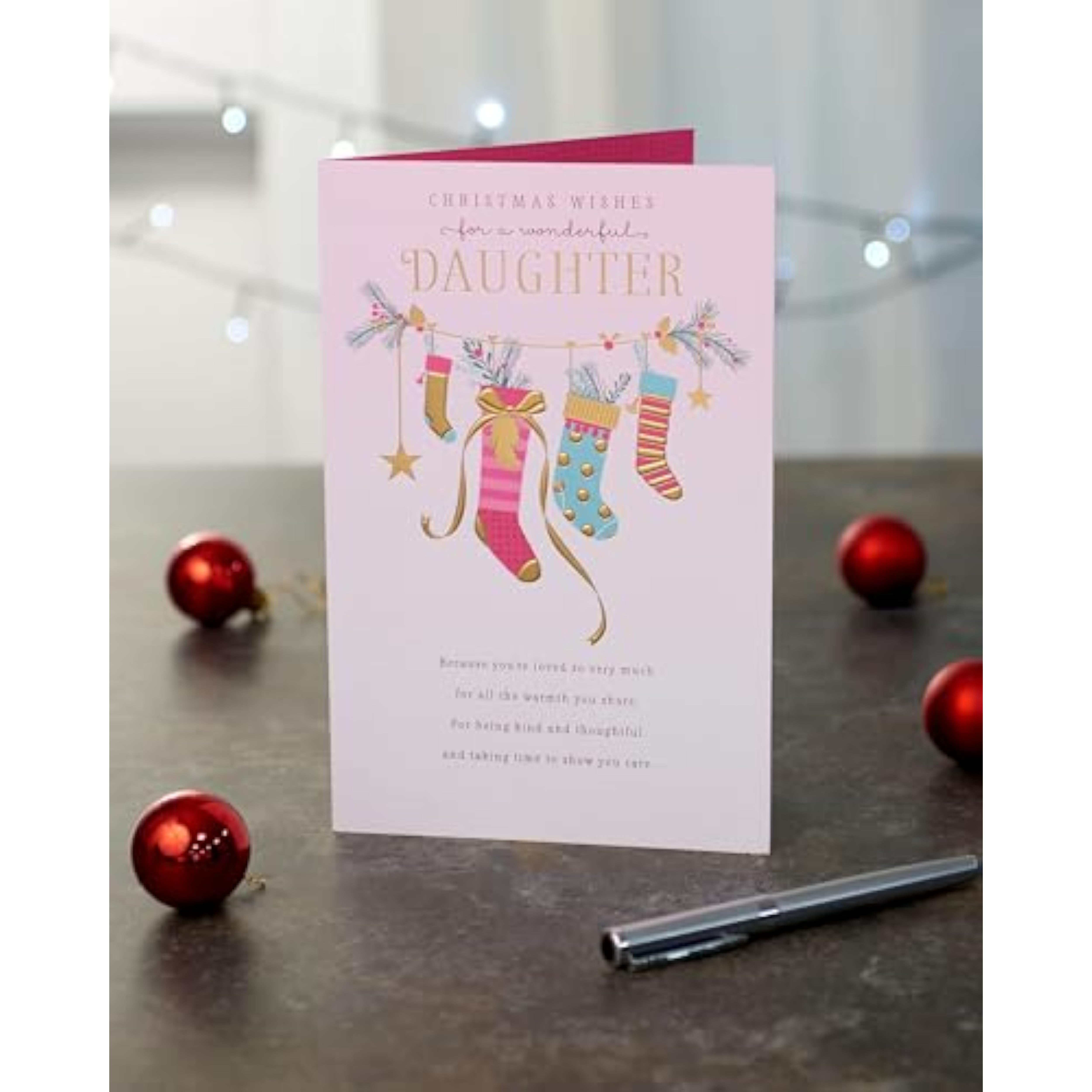Pink Christmas greeting card for daughter featuring stockings and holiday design by UKG, perfect for warm holiday wishes.