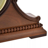 Wooden Napoleon mantel clock by Widdop & Co with intricate detailing and classic design, placed on a wooden surface.